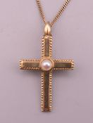 A 9 ct gold and seed pearl cross form pendant on chain. Cross 3 cm high, chain 41 cm long. 3.