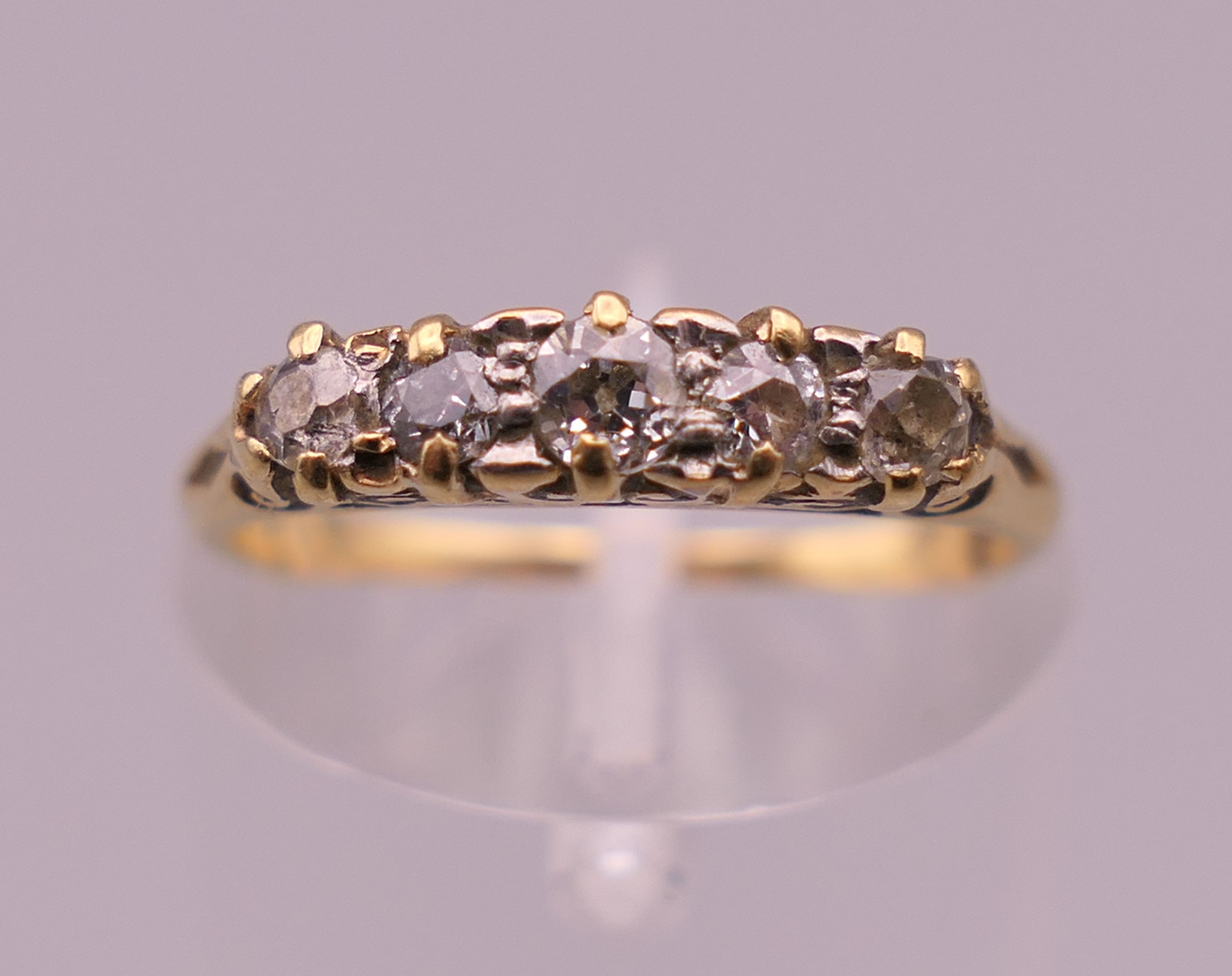 An 18 ct gold five stone diamond ring. Ring size I/J. 1.9 grammes total weight.