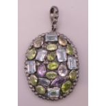 A silver peridot, diamond, amethyst and blue topaz pendant. 4 cm high excluding suspension loop.