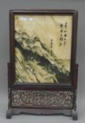 A Chinese hardwood framed table screen. 79.5 cm high.