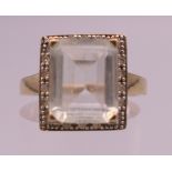 A 9 K gold, pale aquamarine and diamond ring. Ring size O. 3.1 grammes total weight.