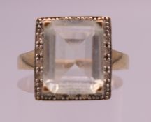 A 9 K gold, pale aquamarine and diamond ring. Ring size O. 3.1 grammes total weight.