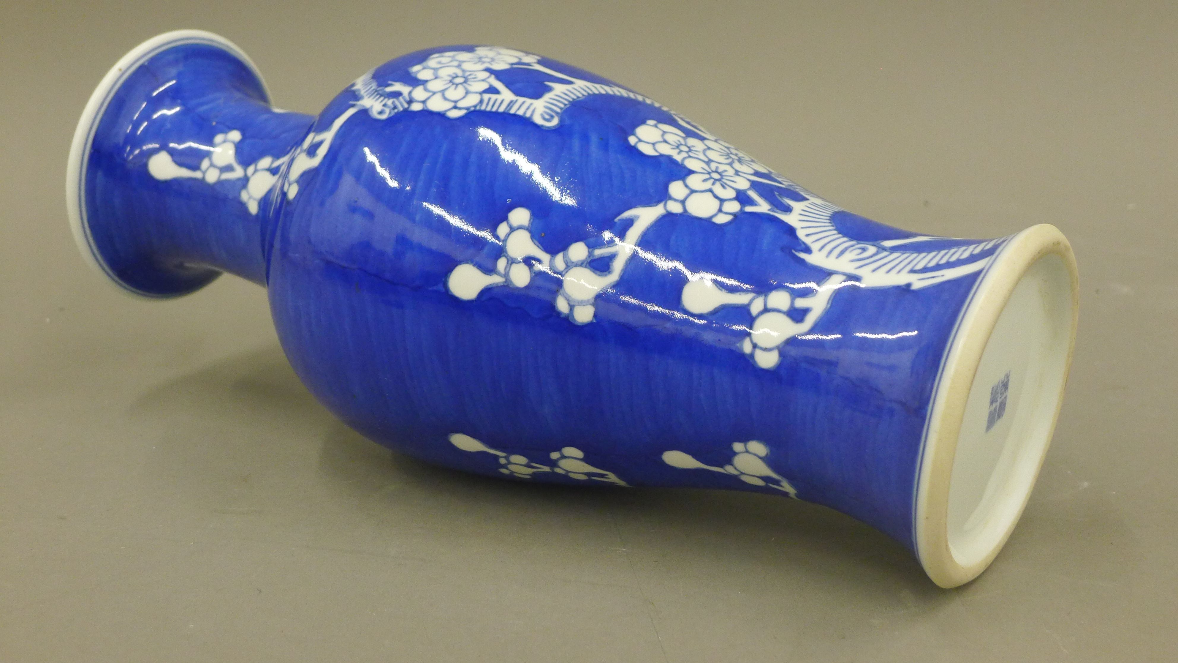 A Chinese blue and white porcelain vase decorated with prunus blossom, with character mark to base. - Image 3 of 4