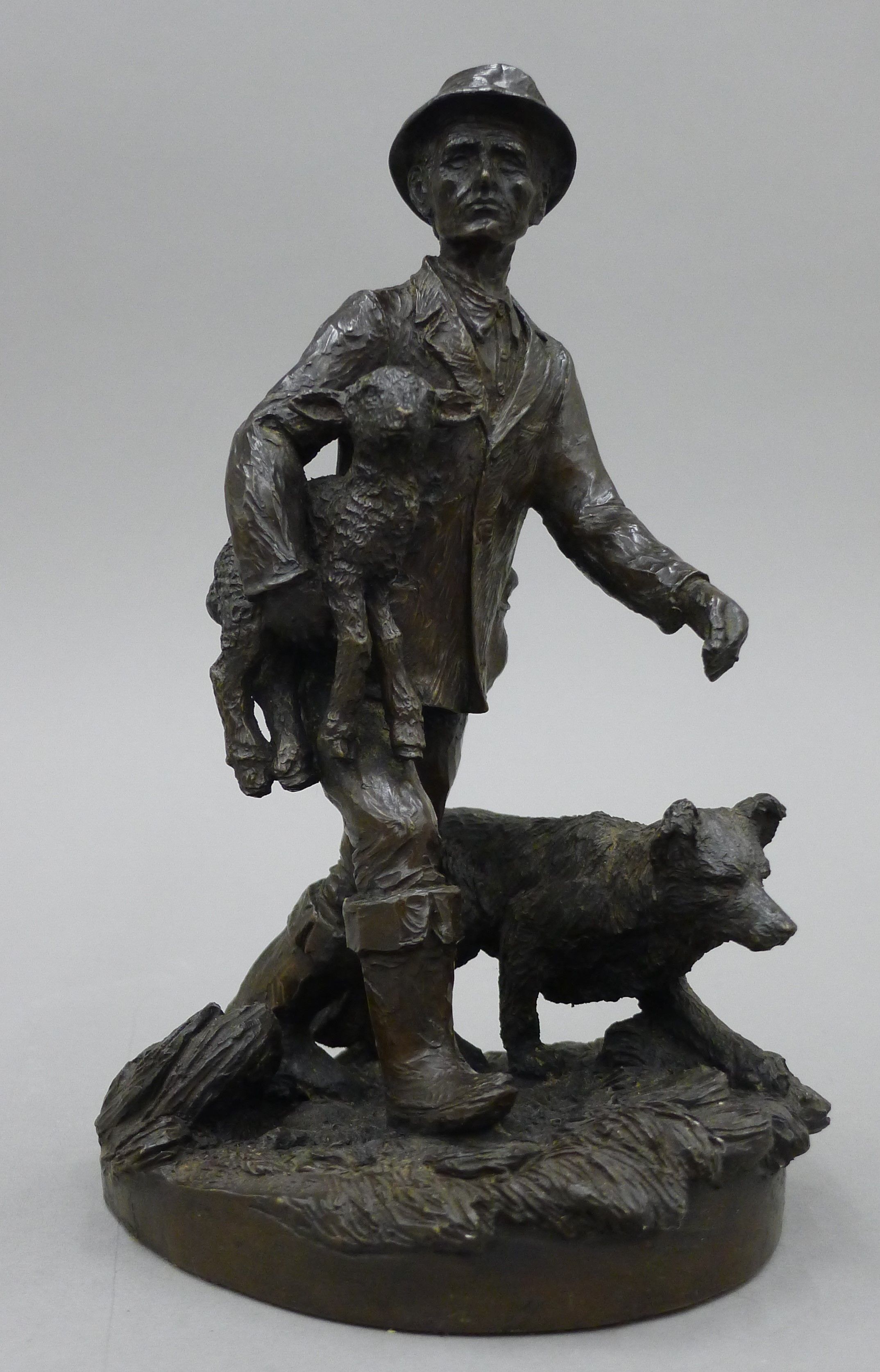 A model of a shepherd and dog with a lost lamb. 22 cm high.