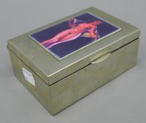 A silver plated cigarette box, the top decorated with a female nude. 13 cm wide.
