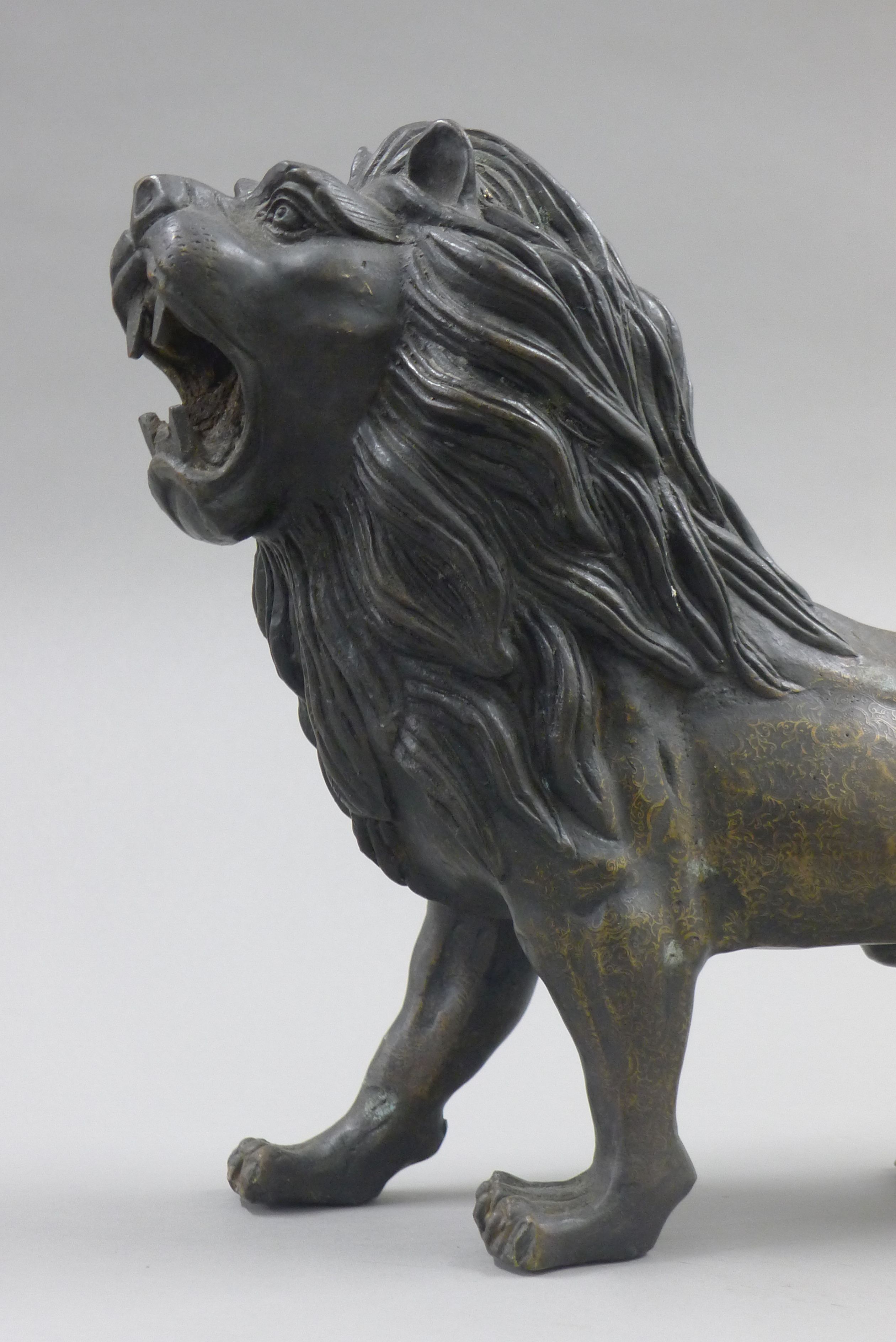 A bronze model of a lion. 56 cm long. - Image 2 of 3