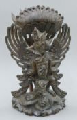 An Eastern carved model of a deity. 30.5 cm high.