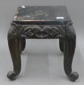 An Anglo Indian carved ebony stool. 35 cm squared.