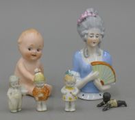 A small collection of bisque porcelain dolls, small figurines and a porcelain half doll.