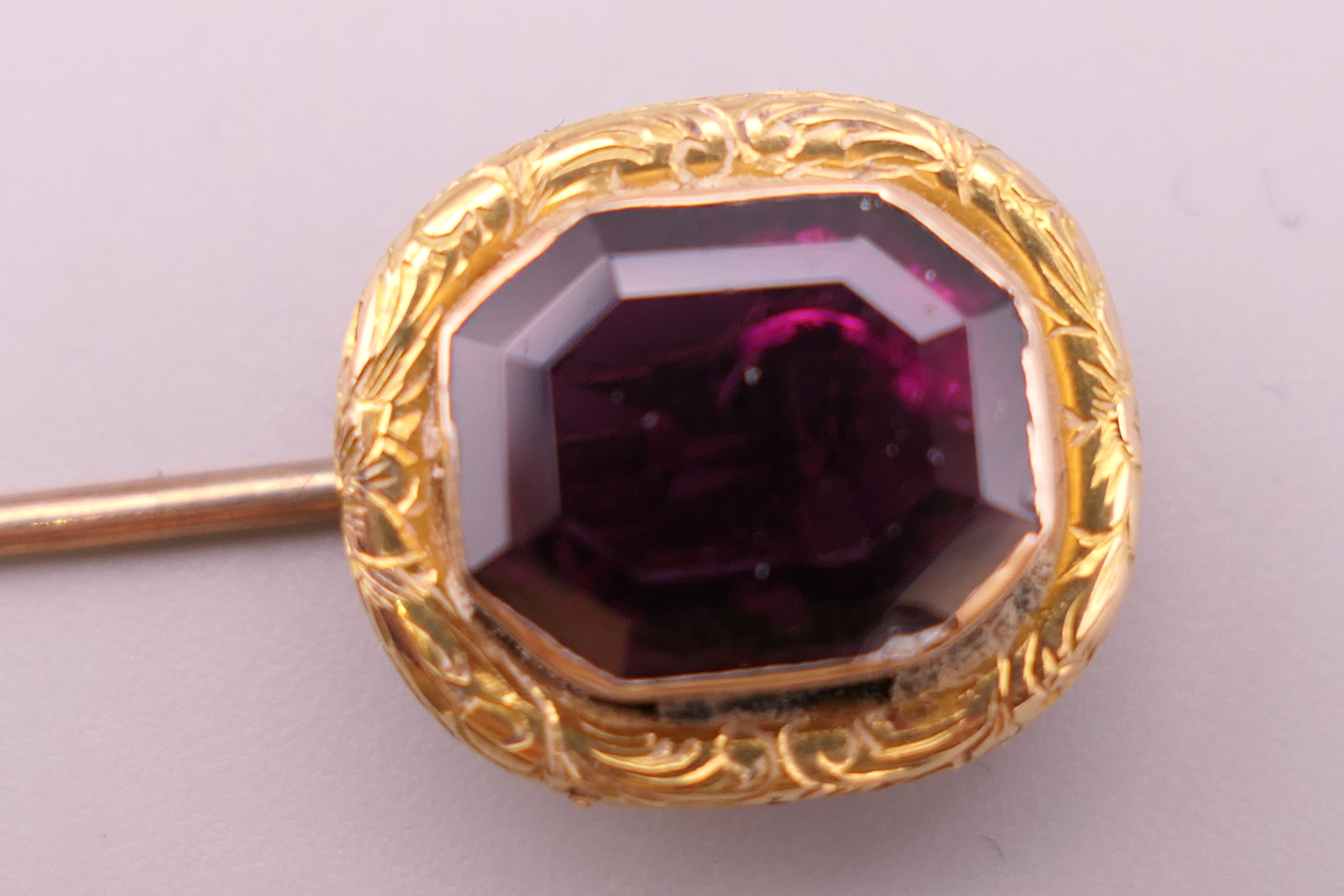 An antique unmarked gold purple stone stickpin, possibly garnet, boxed. 8 cm high. 3. - Image 4 of 6