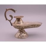 A silver, possibly Egyptian, oil lamp form table lighter. 10 cm long.