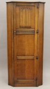 A mid-20th century oak veneered hall wardrobe and matching side cabinet. The former 177 cm high.