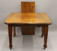 A late 19th/early 20th century oak single leaf wind out dining table. 146 cm long extended.