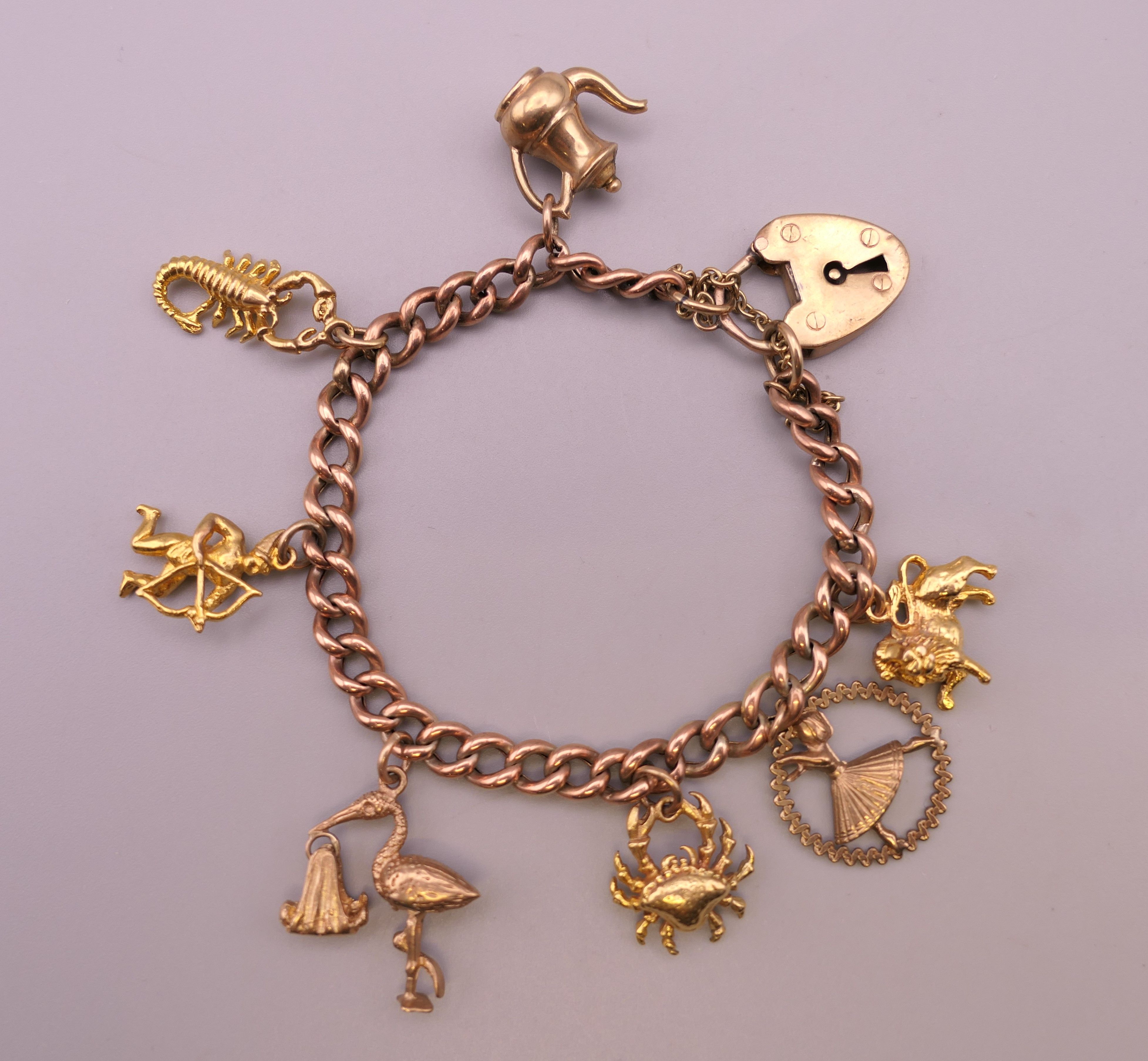 A 9 ct gold charm bracelet. Approximately 14 cm long. 18.4 grammes.