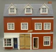 A furnished doll's house. 80 cm wide.