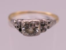 An antique unmarked gold diamond ring, the central stone spreading to approximately 0.75 carats.