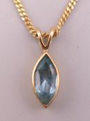 An aquamarine pendant on a 9 ct gold chain. Pendant 1 cm high, chain 40 cm long. 2.