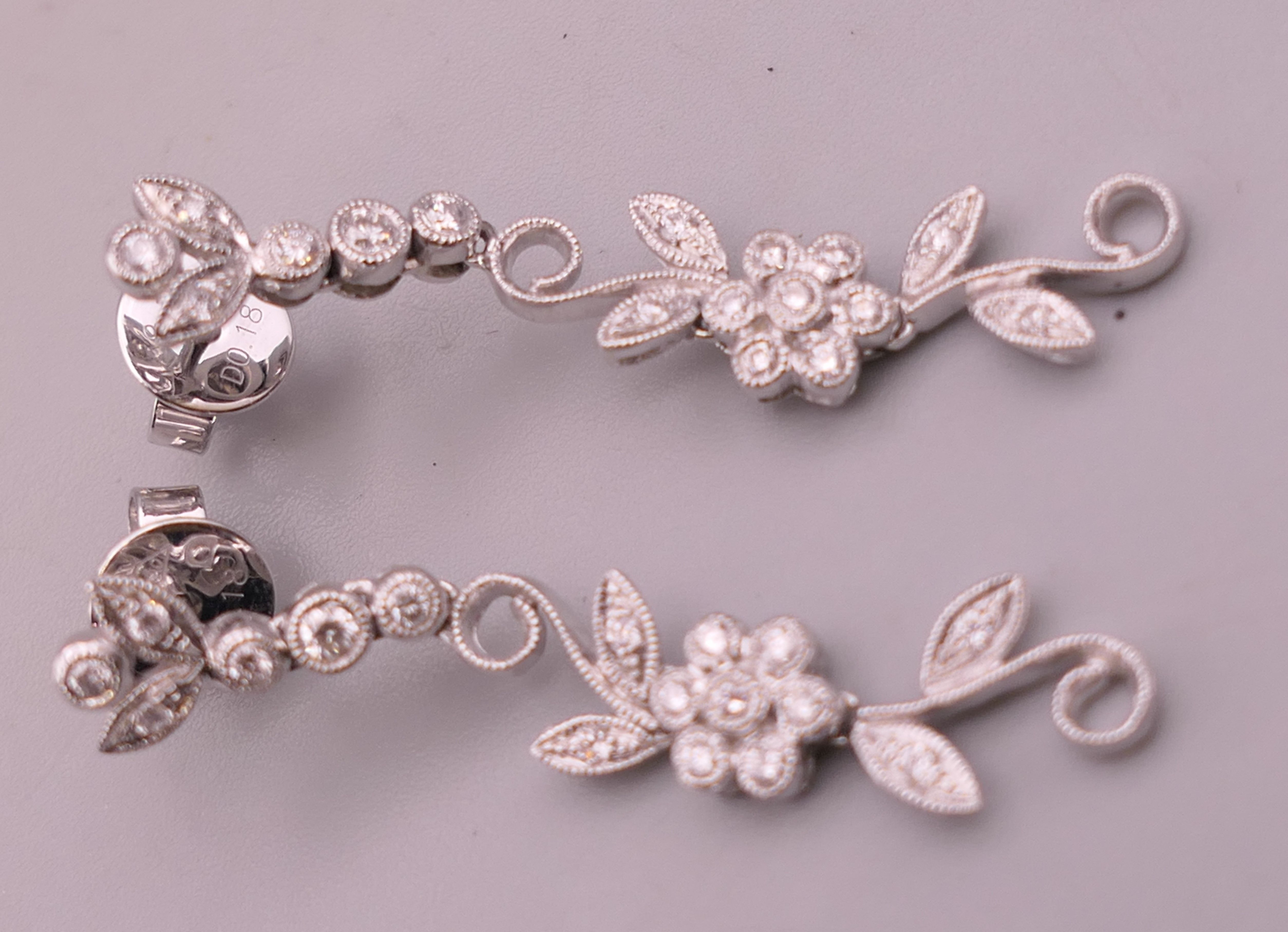 A pair of 18 ct white gold diamond flower drop earrings. Approximately 4 cm long. - Image 7 of 12