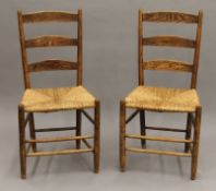 A pair of 19th century rush seated ladder back chairs. 48 cm wide.