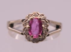An 18 ct white gold, Burmese ruby and diamond ring. Ring size O/P. 4.7 grammes total weight.