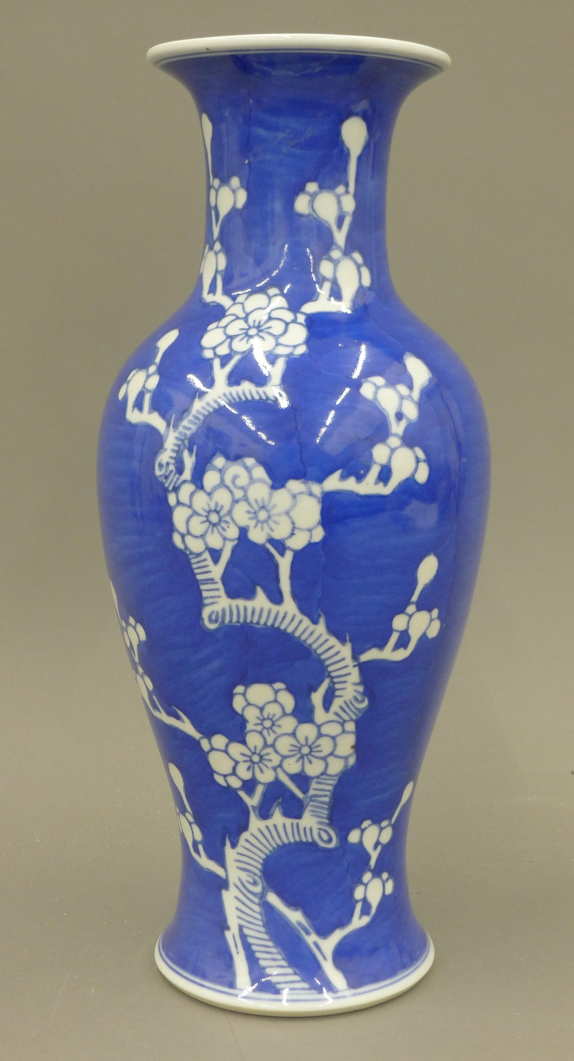 A Chinese blue and white porcelain vase decorated with prunus blossom, with character mark to base. - Image 2 of 4