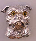 A silver dog's head form brooch. 3 cm high.