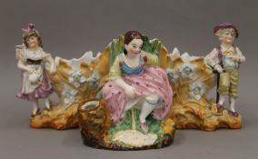 A 19th century porcelain figure modelled as a young girl having a tinkle and a pair of Continental