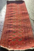 A red ground wool runner. 80 x 265 cm.