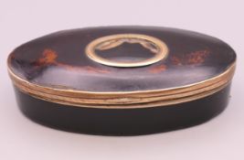 A George III faux tortoiseshell papier mache oval snuff box with hardstone inset to lid,