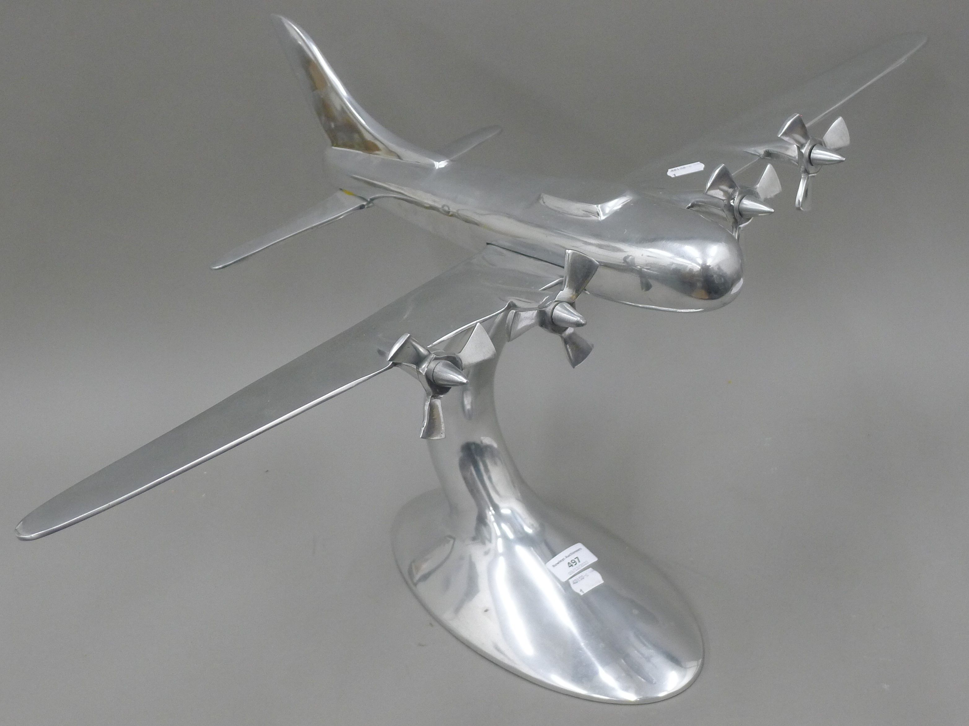 A large aluminium model of a four engine bomber plane. 80 cm wide.