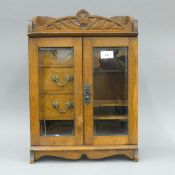 A Victorian oak smoker's cabinet. 46 cm high.