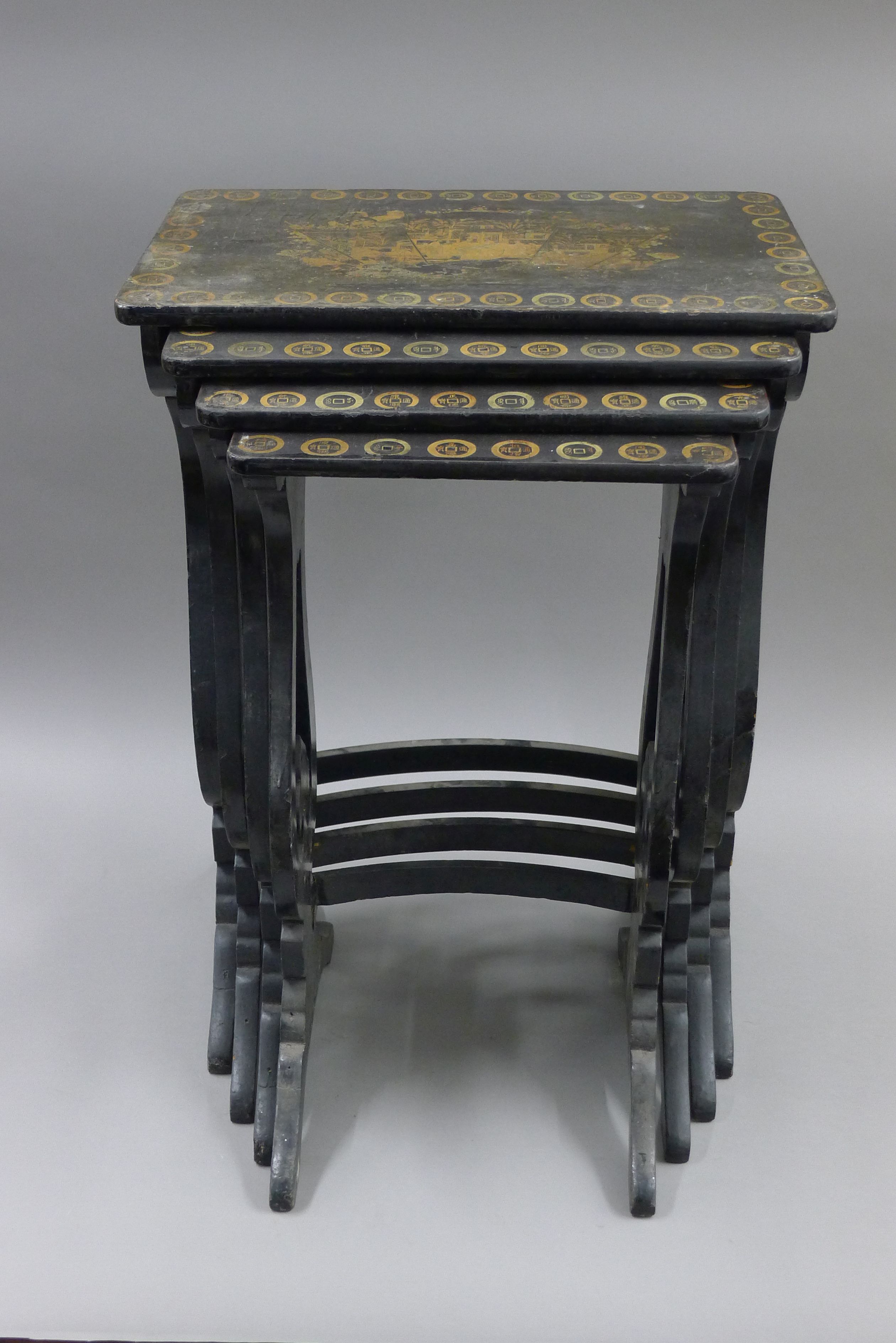 A chinoiserie lacquered nest of four tables. 50 cm wide.