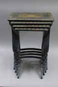 A chinoiserie lacquered nest of four tables. 50 cm wide.