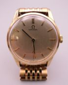 A 9 ct gold Omega gentlemen's wristwatch on a plated stainless steel strap. 3.5 cm wide.
