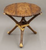 An African folding tripod table. 63 cm diameter.