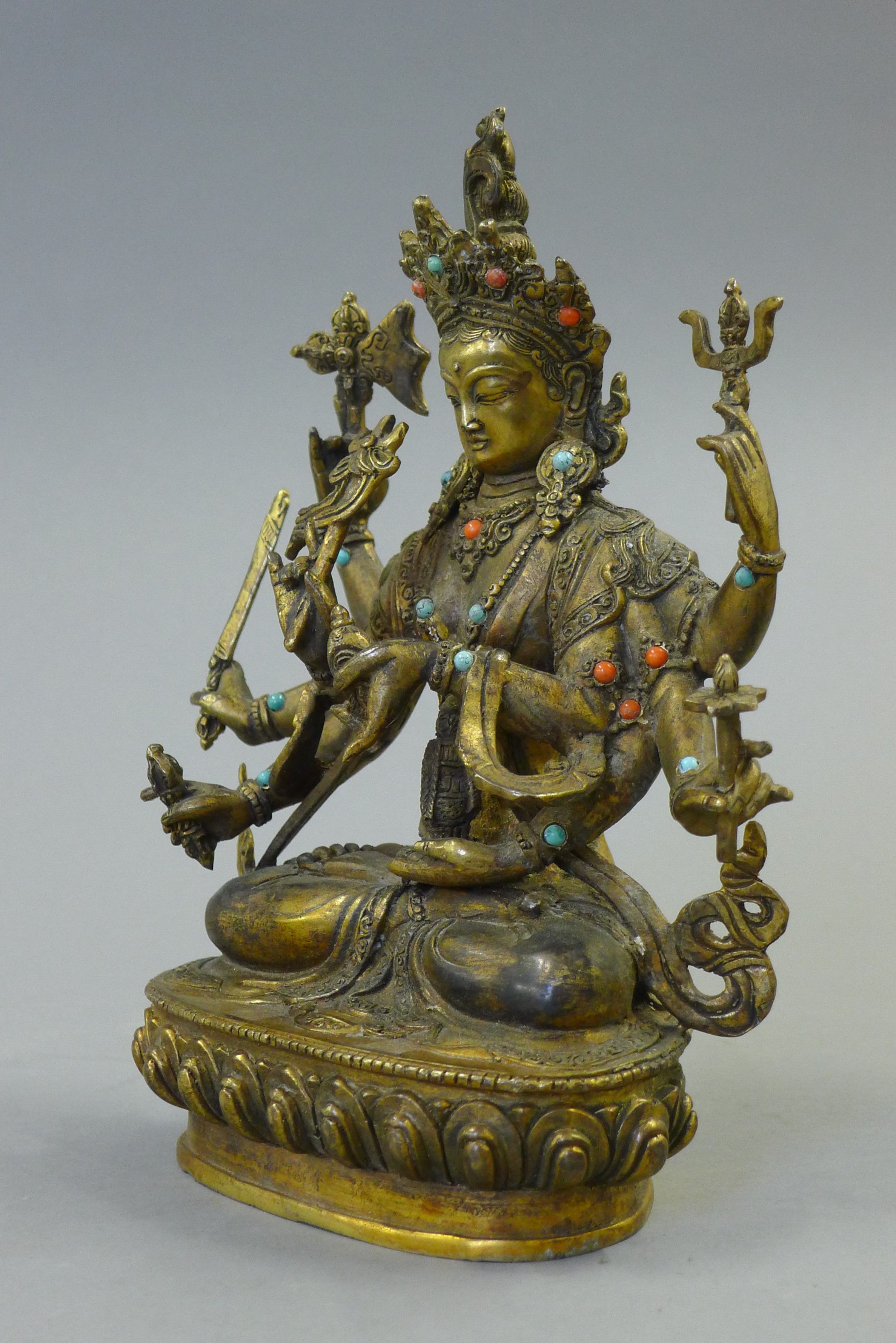 A gilt bronze model of a deity decorated with coral and turquoise. 21.5 cm high. - Image 3 of 5