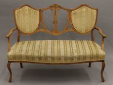 An Edwardian upholstered parlour settee. Approximately 122 cm long.