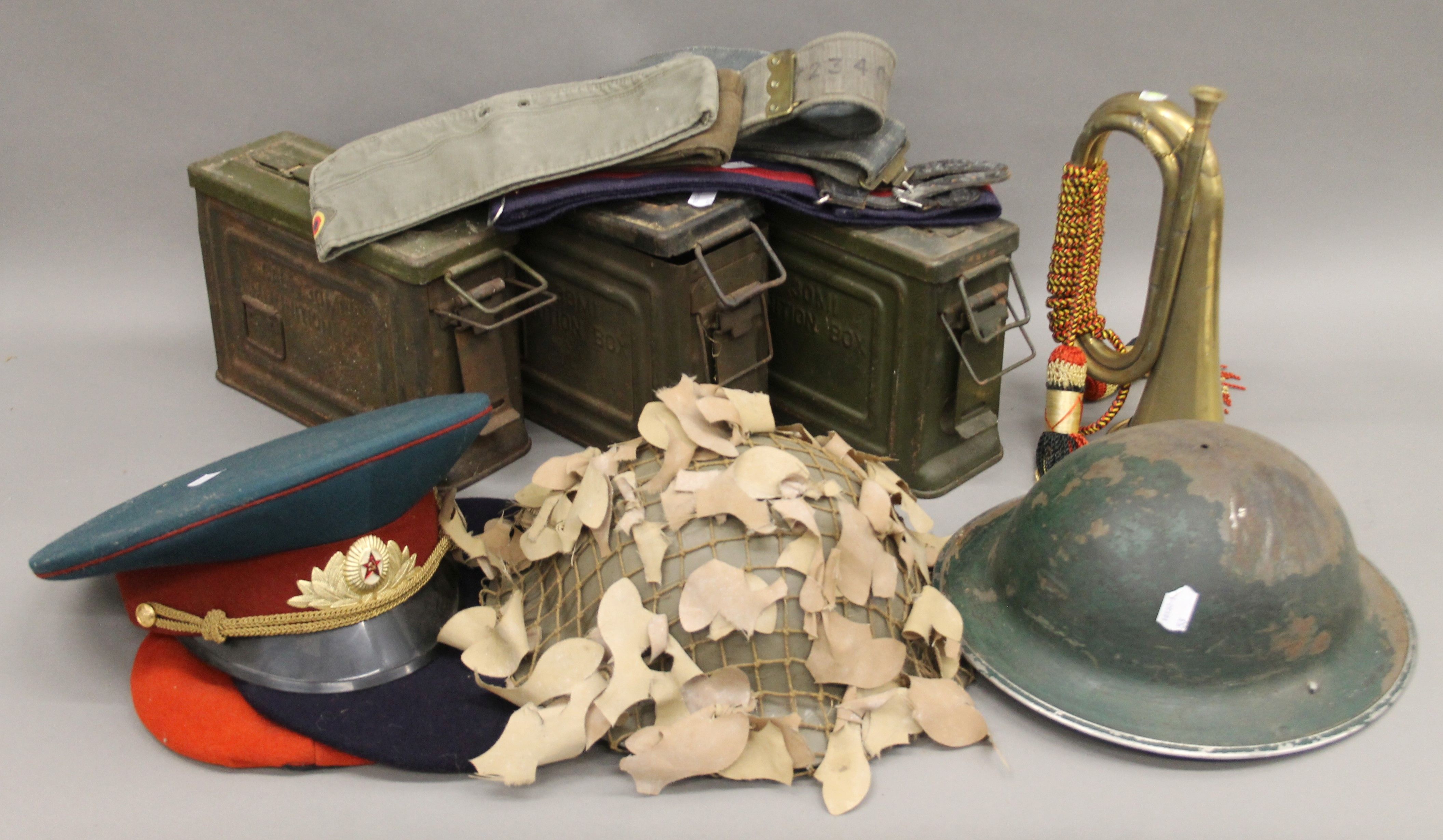 A quantity of various militaria, including helmets, belts, ammunition boxes, etc.