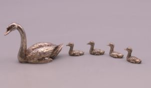 A solid silver model of a swan and four signets, hallmarked for London 1988. Swan 3.