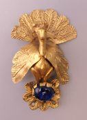 A Persian brooch with blue glass cabochon. 5.5 cm high.