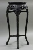 A late 19th century Chinese marble top stand. 77 cm high.