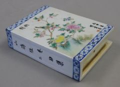 A Chinese famille rose porcelain book form pillow. 14 cm high.