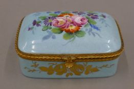 A French porcelain box painted with flowers. 11 cm wide.