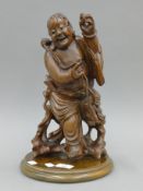 A carved Chinese model of Shou Lao, on a wooden base. 36 cm high.