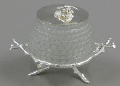 A silver plated and glass honey pot, the lid surmounted with a bee. 11 cm high.