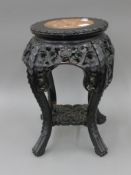 A late 19th century Chinese marble inset urn stand. 48 cm high.