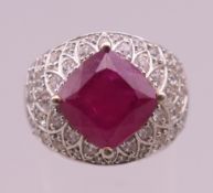 A silver, red stone and cubic zirconia ring. Ring size Q/R.