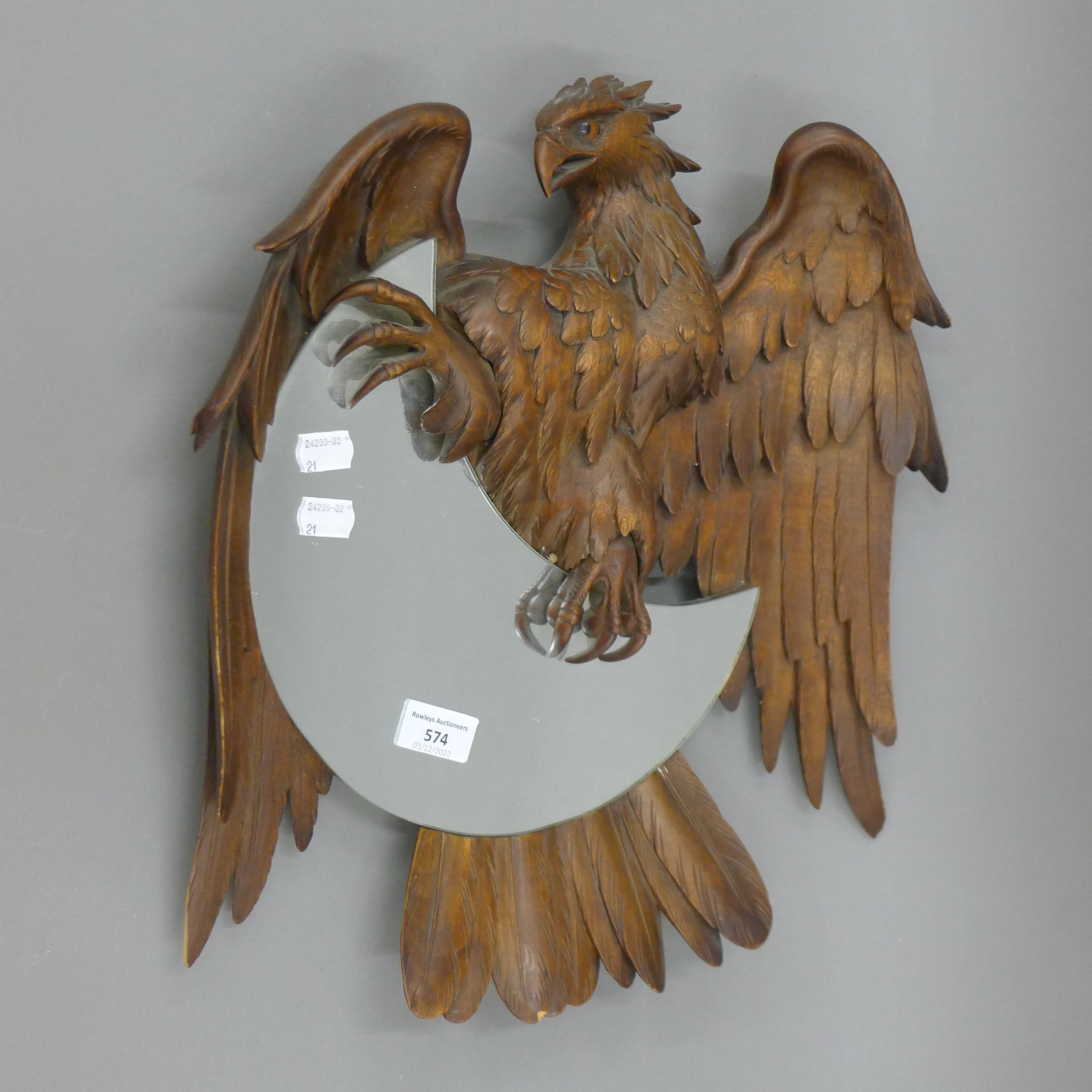 A 19th century Blackforest carved wooden mirror formed as a bird of prey. 43.5 cm high.