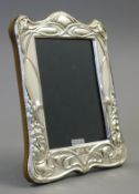 An Art Nouveau style silver photograph frame. 20 cm high.