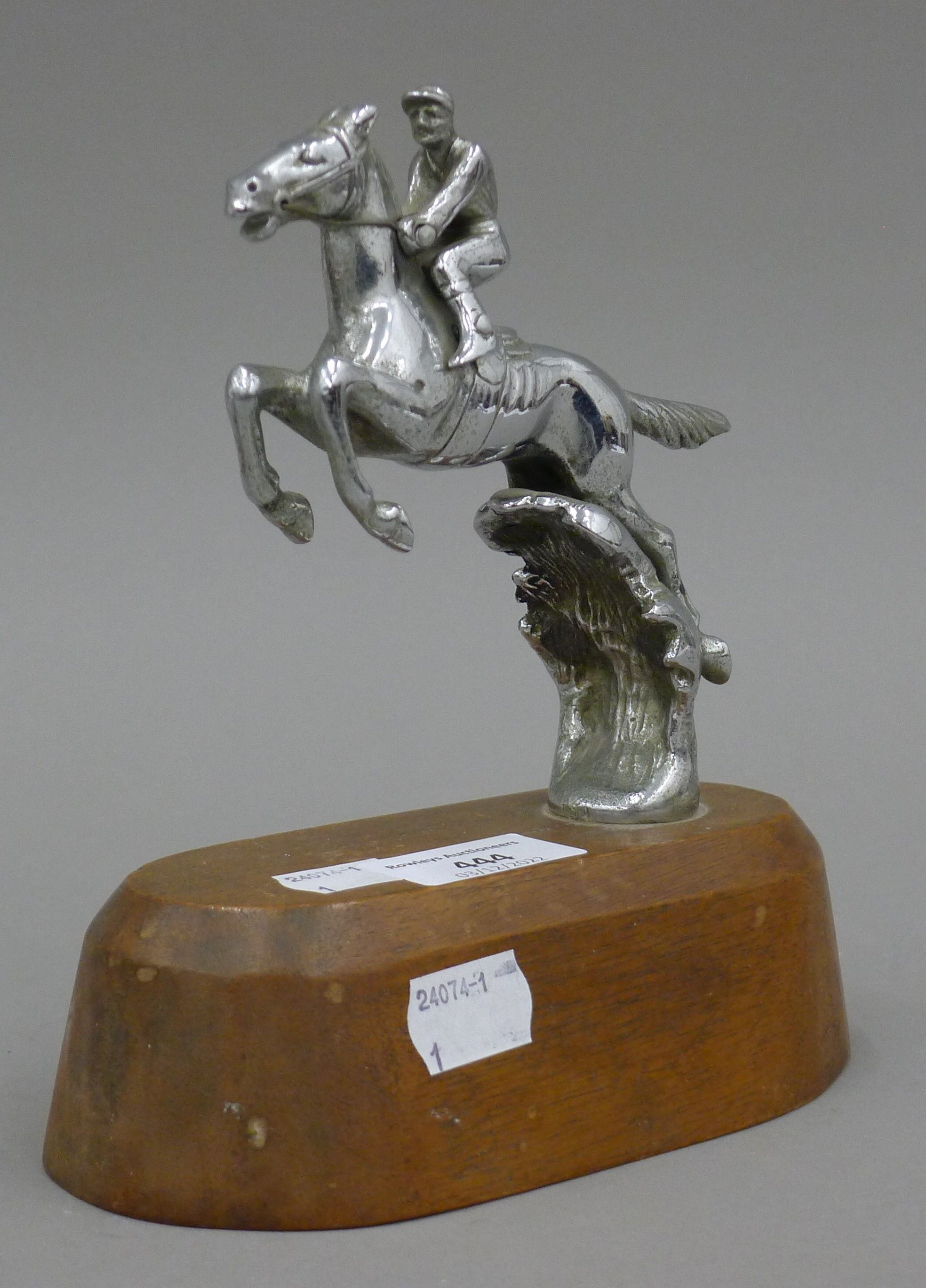 A mid-20th century car mascot formed as a leaping horse and jockey, mounted on a wooden stand. 17. - Image 2 of 3